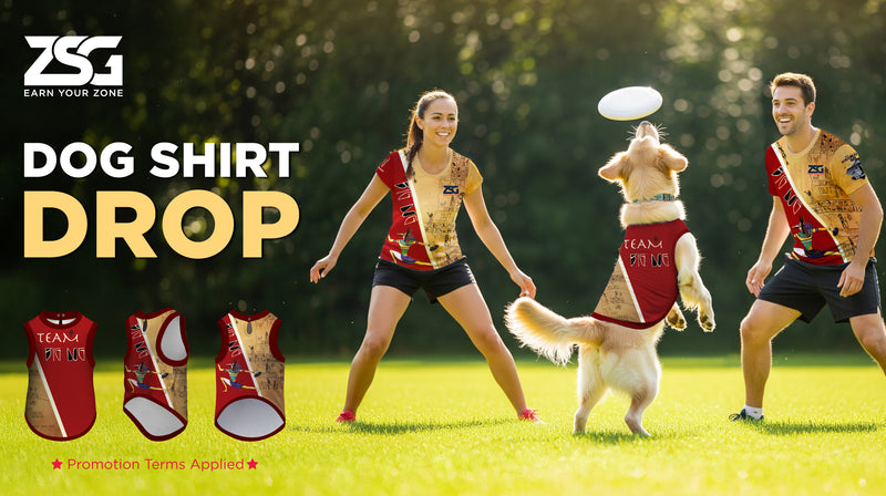 Two ultimate players playing with a dog wearing a custom dog shirt on a grassy field.